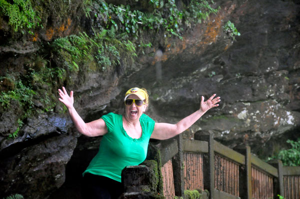 Karen Duquette getting a few water sprinkles  under Dry Falls